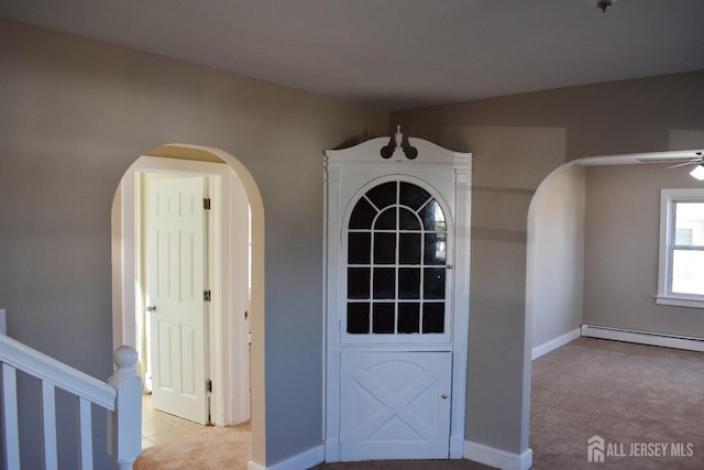 30 John St, South River, NJ 08882 - interior space featuring arched walkways, ceiling fan, baseboards, tile patterned flooring, and a baseboard radiator