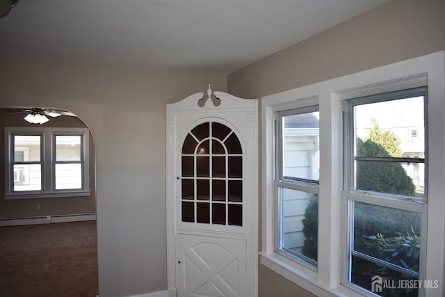 30 John St, South River, NJ 08882 - doorway to outside featuring dark carpet, a ceiling fan, baseboard heating, and a healthy amount of sunlight