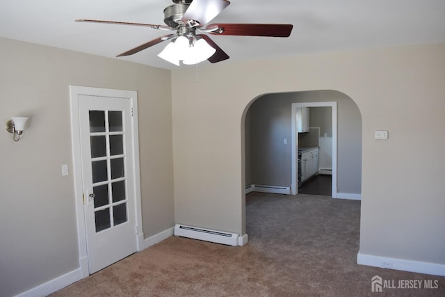 30 John St, South River, NJ 08882 - empty room with ceiling fan, dark carpet, arched walkways, baseboard heating, and a baseboard radiator
