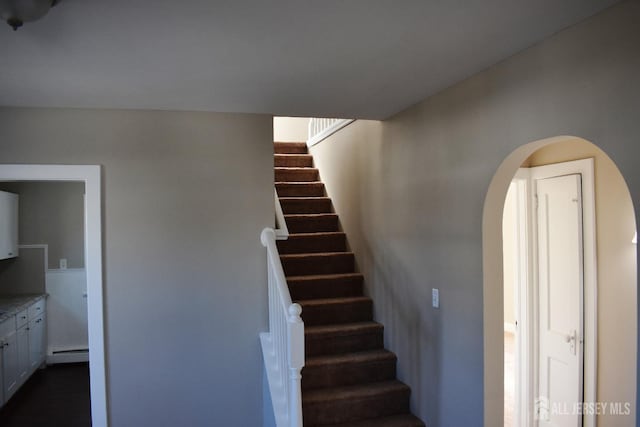 30 John St, South River, NJ 08882 - stairs with arched walkways and a baseboard radiator