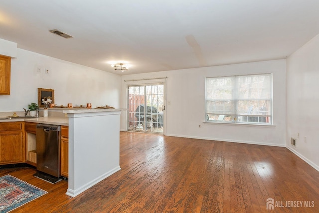 kitchen with visible vents, dark wood finished floors, dishwasher, light countertops, and brown cabinets