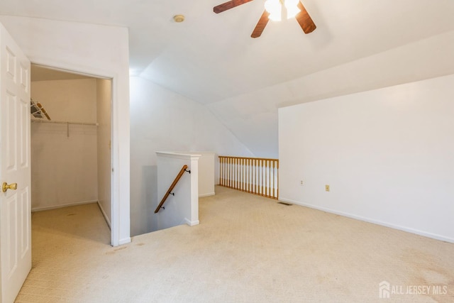 bonus room featuring visible vents, baseboards, lofted ceiling, carpet floors, and a ceiling fan