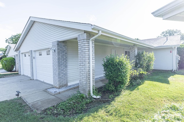372-B Duranta Plz, Monroe, NJ 08831 - view of side of property with brick siding, a yard, and a garage