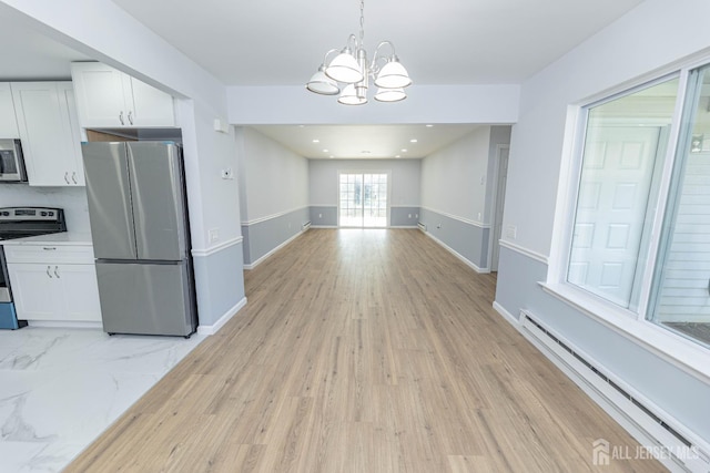 372-B Duranta Plz, Monroe, NJ 08831 - unfurnished dining area with a baseboard radiator, a chandelier, and light wood-type flooring