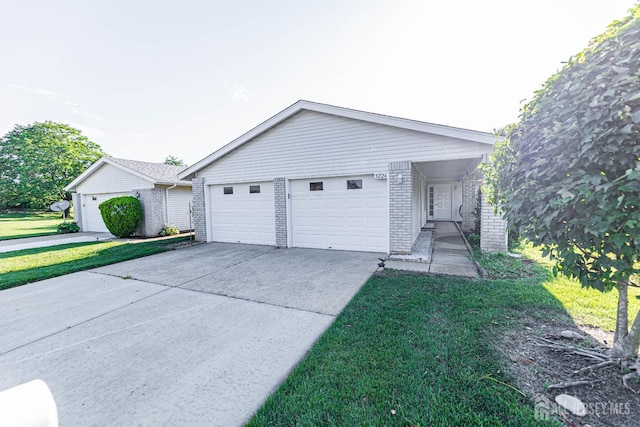 372-B Duranta Plz, Monroe, NJ 08831 - view of front of property featuring brick siding, driveway, a front lawn, and an attached garage