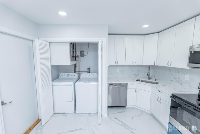 372-B Duranta Plz, Monroe, NJ 08831 - kitchen featuring stainless steel appliances, washer and clothes dryer, white cabinets, recessed lighting, and light marble finish floors