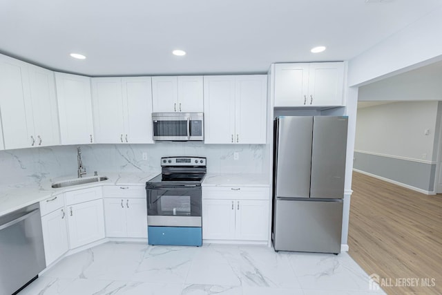372-B Duranta Plz, Monroe, NJ 08831 - kitchen with appliances with stainless steel finishes, light stone countertops, white cabinets, recessed lighting, and tasteful backsplash