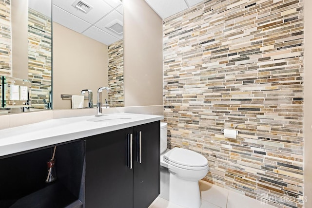 6 Alex Ct, Monroe, NJ 08831 - bathroom featuring toilet, a paneled ceiling, tile patterned floors, vanity, and tile walls