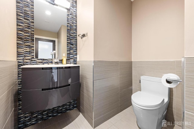 6 Alex Ct, Monroe, NJ 08831 - bathroom featuring tile walls, tile patterned floors, a wainscoted wall, toilet, and vanity