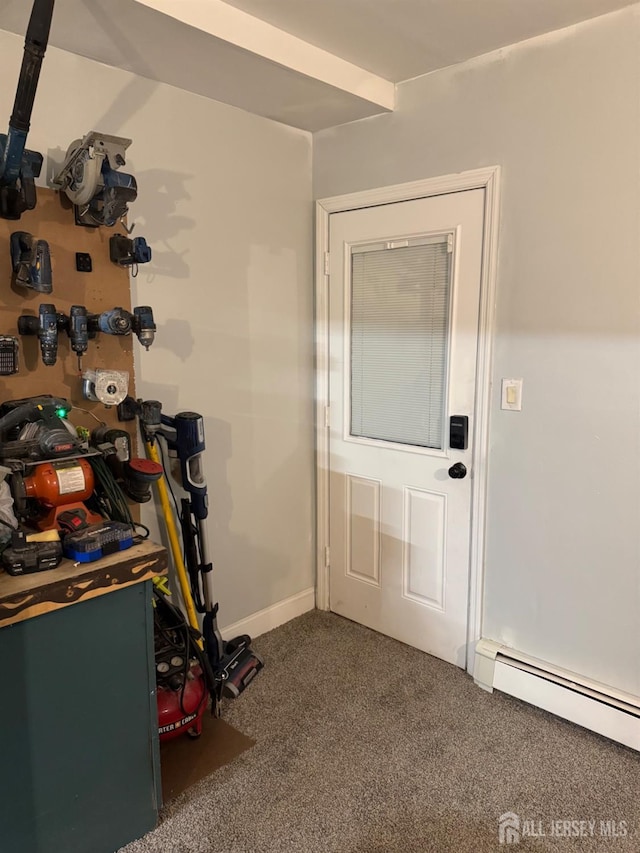 doorway to outside with carpet and a baseboard heating unit