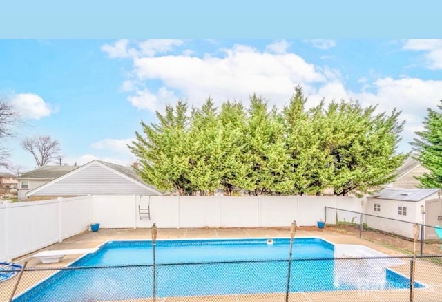 view of pool with a fenced in pool and fence