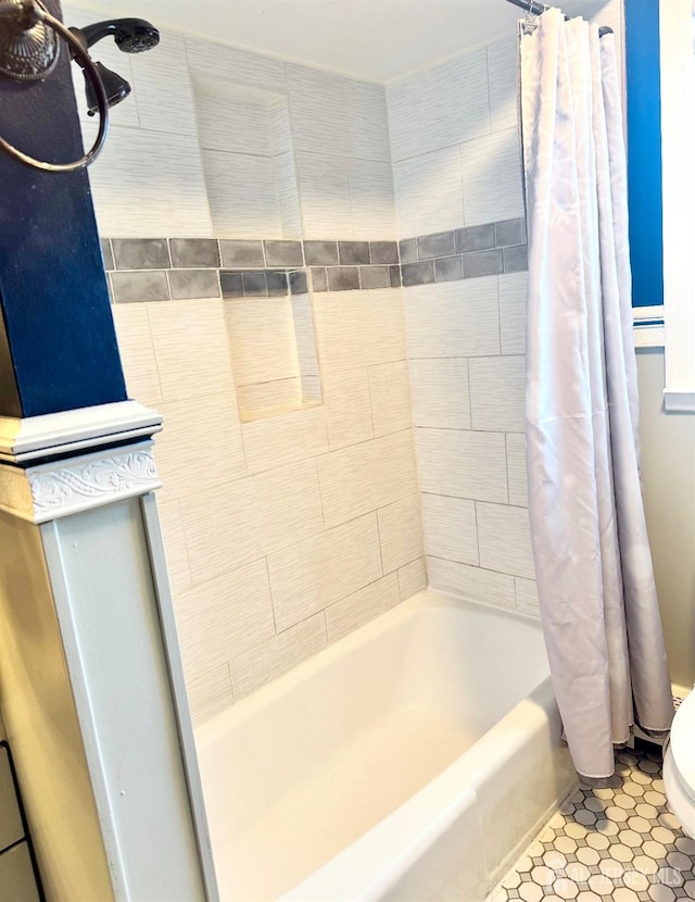 bathroom featuring tile patterned floors, toilet, and shower / bathtub combination with curtain