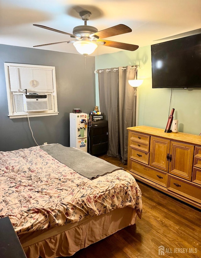 bedroom featuring dark wood-style flooring, cooling unit, and a ceiling fan