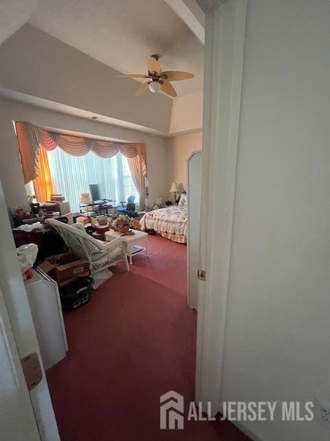 bedroom featuring carpet, ceiling fan, and vaulted ceiling