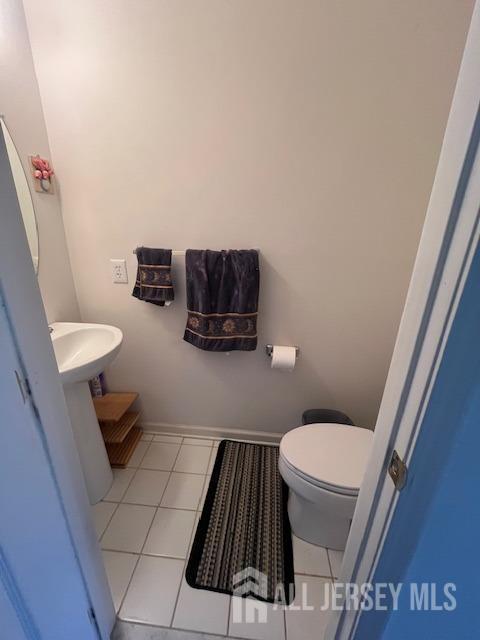47 Stony Path Dr, South Brunswick, NJ 08810 - bathroom with tile patterned flooring, toilet, a sink, and baseboards