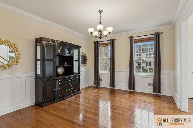 20 Washingtons Xing, Monroe, NJ 08831 - unfurnished dining area featuring a chandelier, hardwood / wood-style floors, crown molding, a wainscoted wall, and a decorative wall