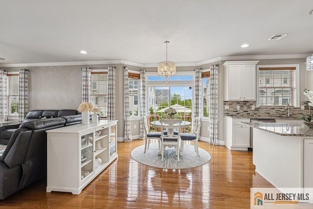 20 Washingtons Xing, Monroe, NJ 08831 - dining area with healthy amount of natural light, crown molding, light wood finished floors, a chandelier, and recessed lighting