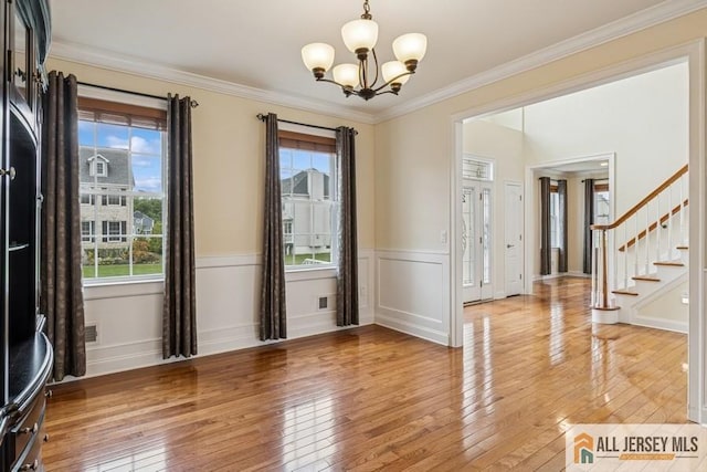 20 Washingtons Xing, Monroe, NJ 08831 - spare room with light wood-style floors, a chandelier, stairway, ornamental molding, and a wainscoted wall