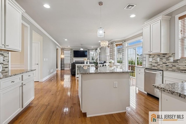 20 Washingtons Xing, Monroe, NJ 08831 - kitchen featuring stainless steel dishwasher, open floor plan, tasteful backsplash, white cabinetry, and a kitchen island