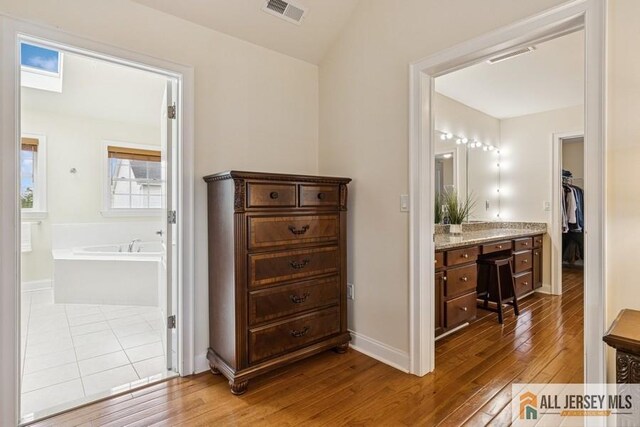 20 Washingtons Xing, Monroe, NJ 08831 - full bath with hardwood / wood-style flooring, vanity, a bath, and baseboards