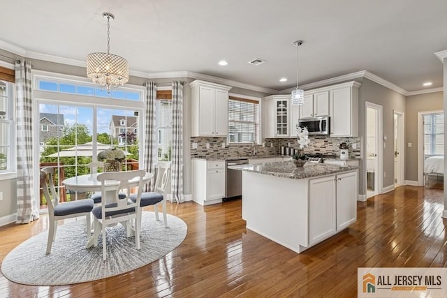 20 Washingtons Xing, Monroe, NJ 08831 - kitchen featuring appliances with stainless steel finishes, white cabinetry, plenty of natural light, decorative backsplash, and crown molding