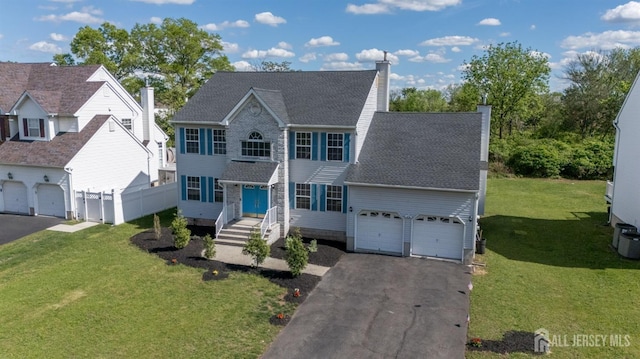 46 Carriage Dr, Piscataway, NJ 08854 - colonial-style house featuring asphalt driveway, a chimney, and roof with shingles