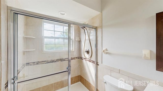 46 Carriage Dr, Piscataway, NJ 08854 - bathroom featuring a shower stall, toilet, and tile walls