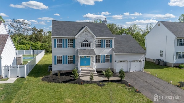 46 Carriage Dr, Piscataway, NJ 08854 - view of front facade with driveway, roof with shingles, a chimney, central AC unit, and a garage