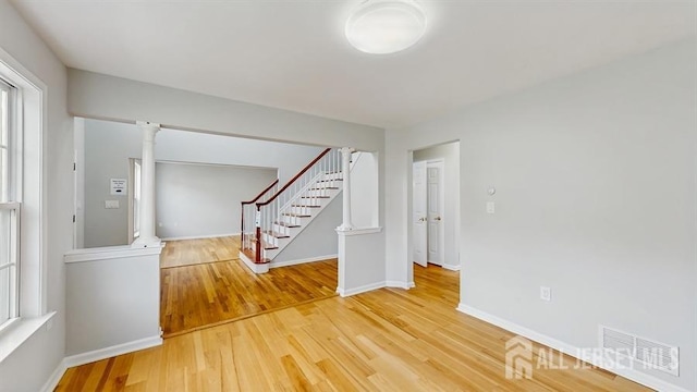 46 Carriage Dr, Piscataway, NJ 08854 - unfurnished room with stairway, light wood-style floors, baseboards, and plenty of natural light