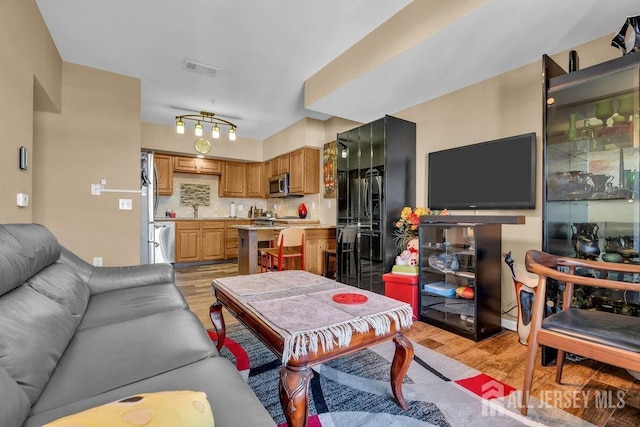 living room featuring sink and light wood-type flooring