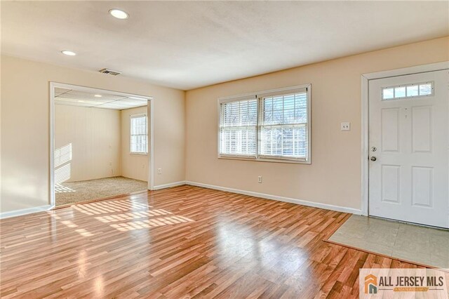 foyer with a healthy amount of sunlight and light hardwood / wood-style floors