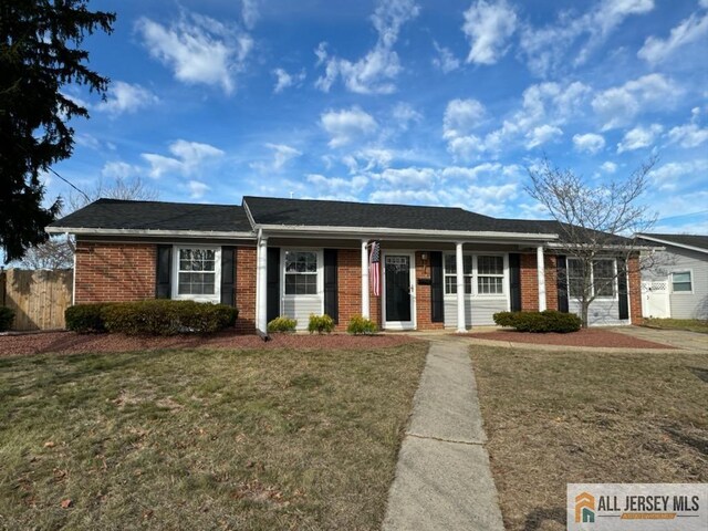 ranch-style home with a front lawn