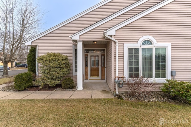 doorway to property with a yard