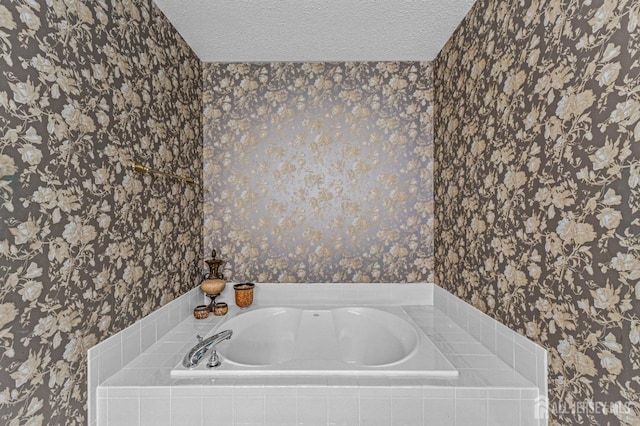 bathroom featuring wallpapered walls, a garden tub, and a textured ceiling