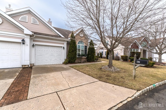 view of front property featuring a garage and a front yard