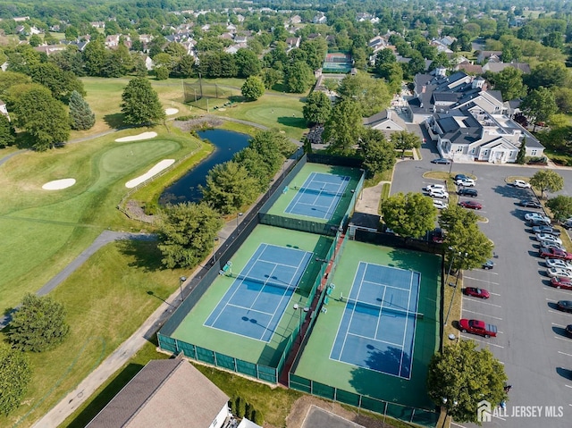 aerial view featuring golf course view and a water view