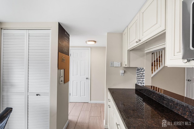 251 Chaucer Ct, Old Bridge, NJ 08857 - kitchen with baseboards, dark stone countertops, white cabinets, and wood finish floors