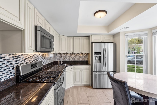 251 Chaucer Ct, Old Bridge, NJ 08857 - kitchen with appliances with stainless steel finishes, a sink, backsplash, and a raised ceiling