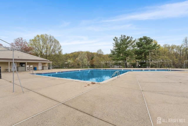 251 Chaucer Ct, Old Bridge, NJ 08857 - community pool with a patio and view of scattered trees