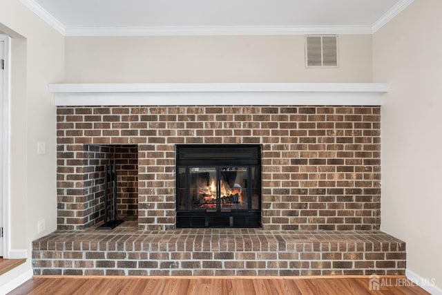 251 Chaucer Ct, Old Bridge, NJ 08857 - detailed view of a brick fireplace, crown molding, wood finished floors, and baseboards