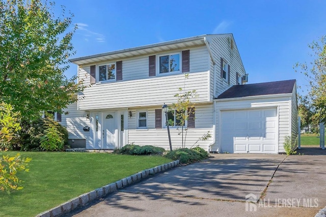 view of front of property featuring a front lawn and a garage