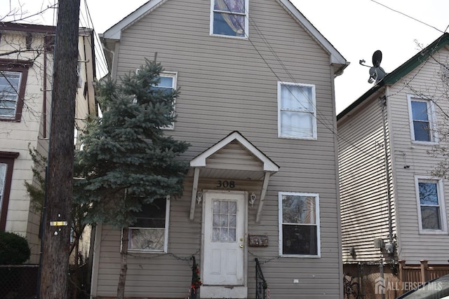 view of front of house featuring fence