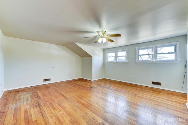 bonus room featuring baseboards, a ceiling fan, visible vents, and light wood-style floors