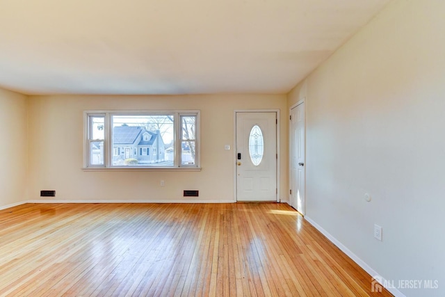 entrance foyer with visible vents, light wood-style flooring, and baseboards