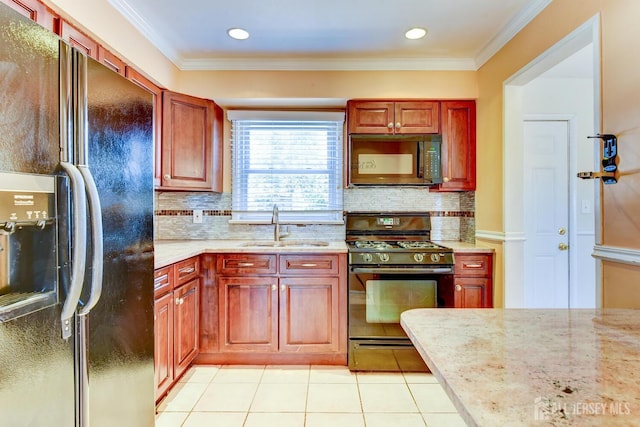 kitchen with light stone countertops, black appliances, crown molding, and a sink