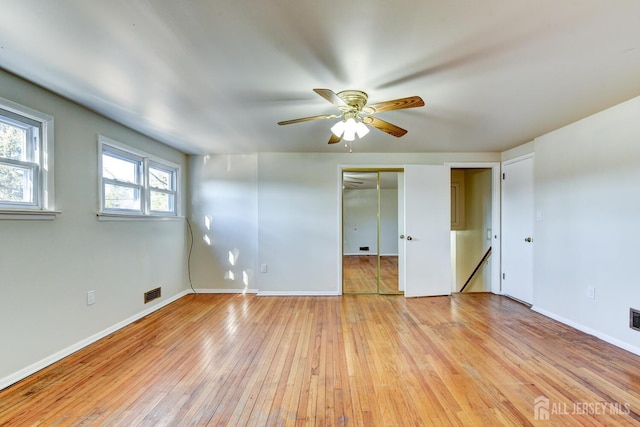 unfurnished bedroom featuring visible vents, a ceiling fan, light wood-style flooring, and baseboards