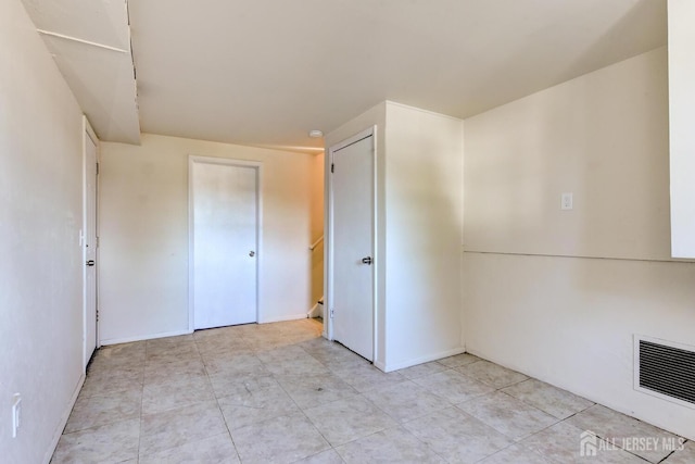 unfurnished bedroom with visible vents