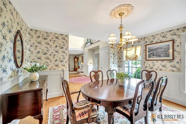 35 Parkview Rd, Cranbury, NJ 08512 - dining area with wallpapered walls, wainscoting, light wood finished floors, a chandelier, and ornamental molding
