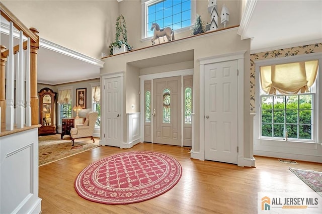 35 Parkview Rd, Cranbury, NJ 08512 - entrance foyer with healthy amount of natural light, ornamental molding, light wood-style floors, and a towering ceiling