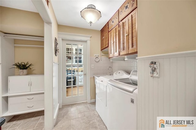 35 Parkview Rd, Cranbury, NJ 08512 - laundry area featuring washing machine and dryer, cabinet space, light stone finish flooring, and a wainscoted wall